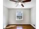 Bedroom with hardwood floors, ceiling fan, and a window at 6296 Flamingo Way, Morrow, GA 30260