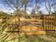 A wooden deck in a backyard setting, with a railing and steps at 6296 Flamingo Way, Morrow, GA 30260