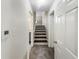 Hallway with stairs featuring patterned carpet and white walls at 6296 Flamingo Way, Morrow, GA 30260