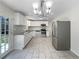 Modern kitchen with stainless steel appliances, white cabinets, granite counters and tile flooring at 6296 Flamingo Way, Morrow, GA 30260