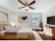 Serene main bedroom featuring hardwood floors, neutral paint, and a cozy ambiance at 6296 Flamingo Way, Morrow, GA 30260