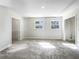 Bright and airy carpeted room with two windows and fresh, white paint at 6296 Flamingo Way, Morrow, GA 30260