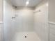 A clean, all-white tile shower featuring modern fixtures at 6296 Flamingo Way, Morrow, GA 30260