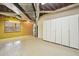 Unfinished basement space featuring exposed ductwork and built-in white storage cabinets at 11710 Mountain Laurel Dr, Roswell, GA 30075