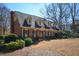 Traditional brick home with dormer windows and professionally landscaped front yard at 11710 Mountain Laurel Dr, Roswell, GA 30075