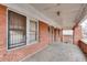 Covered front porch featuring brick columns and a concrete floor at 1523 Melrose Sw Dr, Atlanta, GA 30310