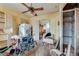 Living room featuring a wheelchair, dated decor, and signs of disrepair throughout the space at 1523 Melrose Sw Dr, Atlanta, GA 30310