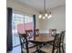 Elegant dining area featuring wood table, stylish chandelier, and sliding glass doors at 3606 Elkhorn Nw Ct, Duluth, GA 30096