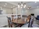 Open-concept dining area with modern lighting, wood table, and view of the living area at 3606 Elkhorn Nw Ct, Duluth, GA 30096