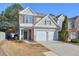 Charming two-story home with a stone facade, white trim, and a two-car garage at 3606 Elkhorn Nw Ct, Duluth, GA 30096