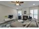 Inviting living room with a fireplace, large windows, and laminate flooring at 3606 Elkhorn Nw Ct, Duluth, GA 30096