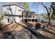 Back of the house with a screened in porch, deck and backyard seating area at 975 Malibu Dr, Marietta, GA 30066