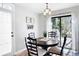 Cozy dining area features a round wooden table, comfortable seating, and natural light from the sliding glass door at 975 Malibu Dr, Marietta, GA 30066