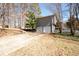 Back of home with a two-car garage and a long concrete driveway at 975 Malibu Dr, Marietta, GA 30066