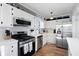 Modern kitchen features stainless steel appliances, white cabinetry, and elegant countertops with a decorative backsplash at 975 Malibu Dr, Marietta, GA 30066