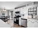 Well-lit kitchen features stainless steel appliances, white cabinets, and access to the outdoor deck area at 975 Malibu Dr, Marietta, GA 30066