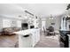Open concept living space with a kitchen island, dining area, and living room with fireplace at 975 Malibu Dr, Marietta, GA 30066