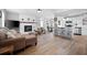 Open-concept living room featuring hardwood floors, fireplace, and kitchen access at 975 Malibu Dr, Marietta, GA 30066
