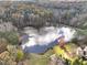 Stunning aerial view of a pond surrounded by mature trees at 102 Rosebury Dr, Canton, GA 30115