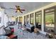 Rear porch with outdoor furniture and multiple ceiling fans at 102 Rosebury Dr, Canton, GA 30115