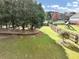 Expansive green backyard, perfect for outdoor activities with trees and a playground in the background at 102 Rosebury Dr, Canton, GA 30115