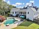 Aerial view of a backyard featuring a pool, spa, and patio space at 102 Rosebury Dr, Canton, GA 30115