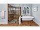 Modern bathroom featuring a clawfoot tub and glass shower with decorative tile work at 102 Rosebury Dr, Canton, GA 30115