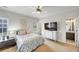 Bright bedroom featuring a comfortable bed, TV, and an adjacent bathroom at 102 Rosebury Dr, Canton, GA 30115