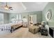 Spacious main bedroom featuring a tray ceiling, sitting area, and doorway to an ensuite bath at 102 Rosebury Dr, Canton, GA 30115