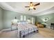 A large main bedroom has a vaulted ceiling, ceiling fan, and a sitting area at 102 Rosebury Dr, Canton, GA 30115