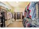 A walk-in closet is highly organized with double rows of hanging clothes at 102 Rosebury Dr, Canton, GA 30115