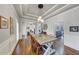 Bright dining room features hardwood floors, white trim, and modern light fixture at 102 Rosebury Dr, Canton, GA 30115