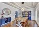 A beautifully decorated dining room offers views of the blue butler's pantry at 102 Rosebury Dr, Canton, GA 30115