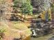 Scenic aerial shot of the lake with dock surrounded by trees at 102 Rosebury Dr, Canton, GA 30115