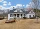 Charming white two-story home featuring a welcoming front porch and beautifully landscaped yard at 102 Rosebury Dr, Canton, GA 30115