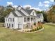 Exterior elevation of a white house with a well landscaped yard at 102 Rosebury Dr, Canton, GA 30115