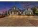 Charming two-story home with a covered front porch, showcasing classic architectural details at 102 Rosebury Dr, Canton, GA 30115