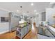 Spacious kitchen featuring hardwood floors, gray cabinets, and a center island, perfect for entertaining guests at 102 Rosebury Dr, Canton, GA 30115