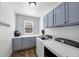 Neat laundry room with washer, dryer, and blue cabinets at 102 Rosebury Dr, Canton, GA 30115