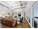 Bright living room with coffered ceiling, built-in shelving, and many windows at 102 Rosebury Dr, Canton, GA 30115