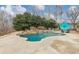 An in-ground backyard pool, with rock waterfall and landscaping at 102 Rosebury Dr, Canton, GA 30115