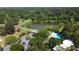 Beautiful aerial shot of tennis courts, a pool, lake, and building surrounded by lush green trees at 18 Cantey Nw Pl, Atlanta, GA 30327