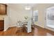 Dining area featuring a glass table, white chairs, hardwood floors and a modern light fixture at 220 Ashley Se Ln # 19, Smyrna, GA 30080
