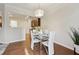 Dining area with a glass table set for four, white chairs, and views into the adjacent kitchen at 220 Ashley Se Ln # 19, Smyrna, GA 30080