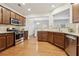 Open-concept kitchen showcasing stainless steel appliances, hardwood floors, and views into the dining area at 220 Ashley Se Ln # 19, Smyrna, GA 30080