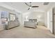 Bright main bedroom featuring a ceiling fan, large dresser, and plush carpet at 220 Ashley Se Ln # 19, Smyrna, GA 30080