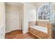 This bathroom features a large window above the soaking tub and tile surround at 2650 Westbury Ct, Suwanee, GA 30024