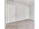 This bedroom has neutral paint and carpet and a double door closet at 2650 Westbury Ct, Suwanee, GA 30024