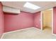 Room with pink walls, carpet flooring, drop ceiling and an open doorway to the hallway at 2650 Westbury Ct, Suwanee, GA 30024