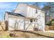 Backyard of a home with white siding, a small patio, and a wooden fence at 594 Waynes Se Ct, Atlanta, GA 30354